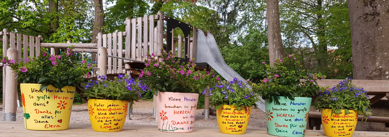 Bunte Blumenbank auf dem Spielplatz des Kindergartens